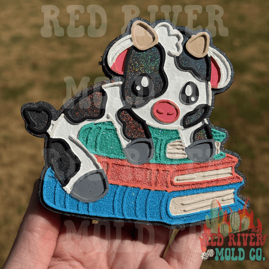 Cow on a stack of books Car Freshie (Cowgirl Cabana Scent) - Red River Mold Co